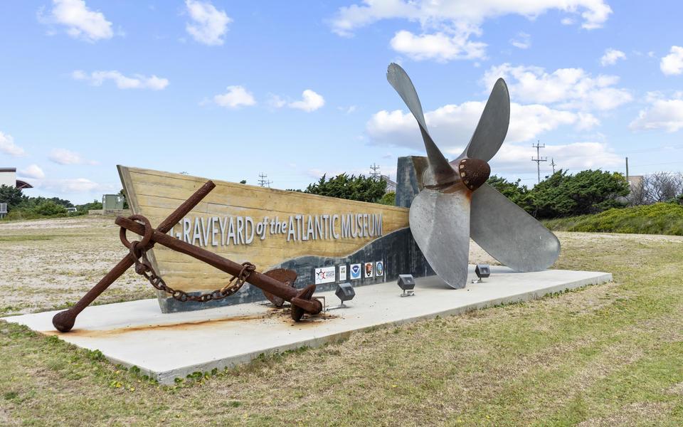 Graveyard of the Atlantic Museum's large sculptural sign featuring a boat hull of concrete and a real propeller and anchor