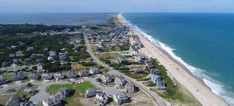 Drone view of the village of Buxton looking in north with the Atlantic Ocean on the right and the Pamlico in the distance