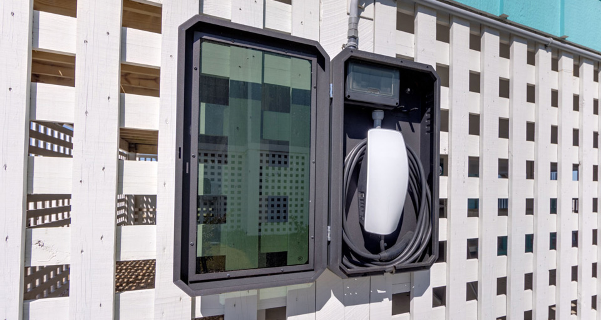 A residential EV charging station on a lattice wall that is part of a Hatteras Island beach house