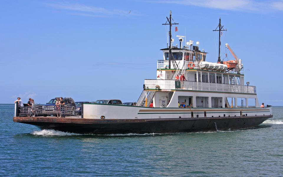 Tight shot of the vehicle ferry going between Hatteras Village and Ocracoke Island on a sunny day full of cars