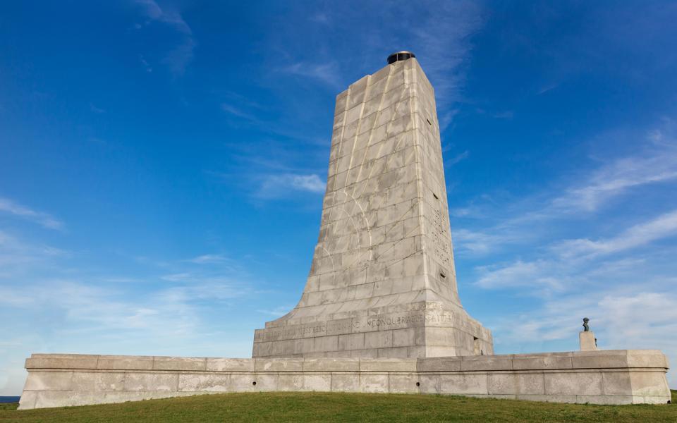 Wright Brothers monument fills the frame against a brilliant blue sky in Kill Devil Hills