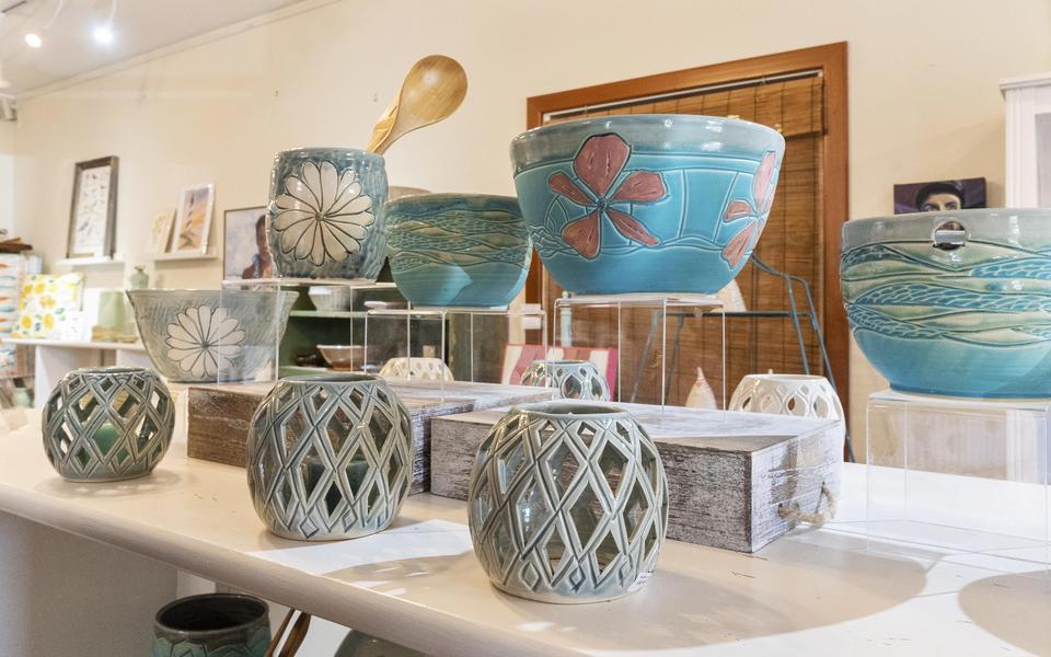 Pottery lines shelves in an airy shop on Hatteras Island. The studio and shop, Kinnakeet Clay, offers classes as well.