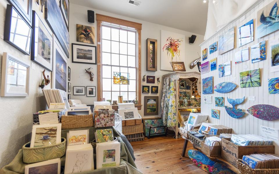 Framed art and sculptural pieces cover the walls of this shop with artful notecards in the foreground.  Fun shopping!
