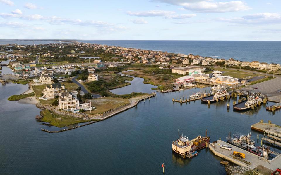 Drone view of the ferry docks in Hatteras Village on a calm windless day, bathed in warm fall light.