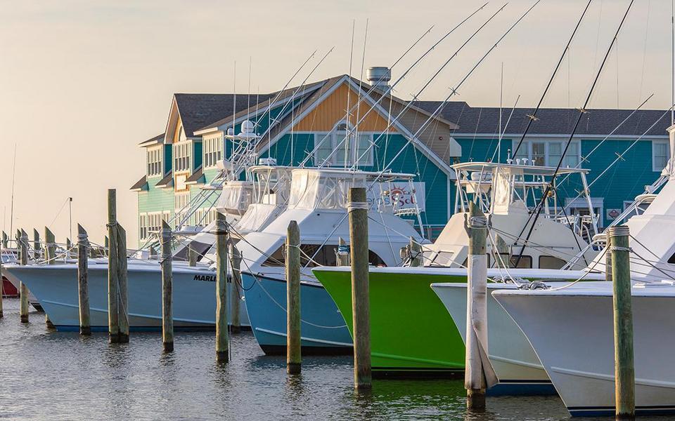 Colorful charter fishing boats awaits summer fishing folk at a marina in Hatteras Village on the OBX