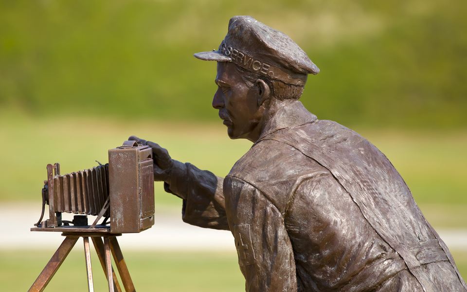 Bronze sculpture detail of John T. Daniels of the Lifesaving Service who took the famous photo of the Wright's 1st flight